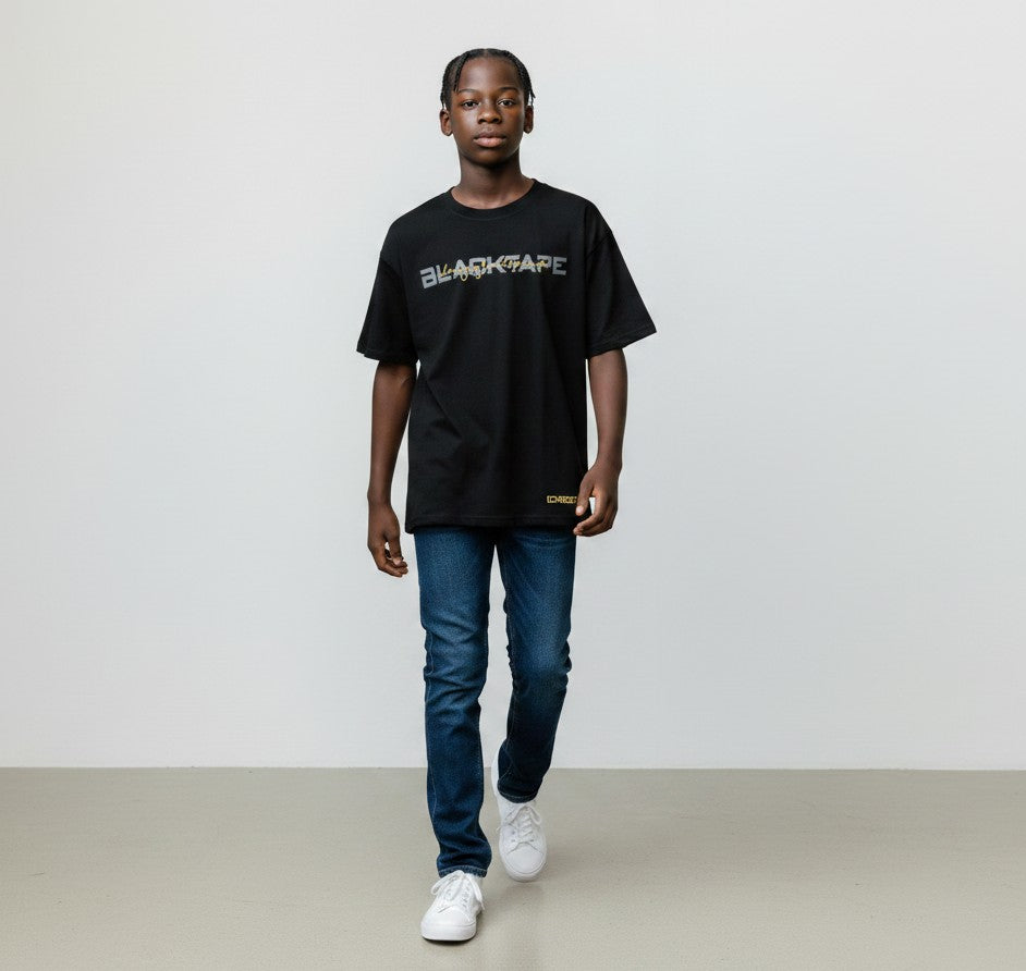 Young man wearing a Blacktapechamchristlike black cotton crew neck t-shirt with graphic print and blue jeans
