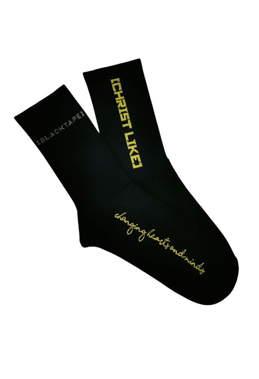 Blacktapechamchristlike Night Sun crew socks in black cotton with yellow embroidered text and branding.