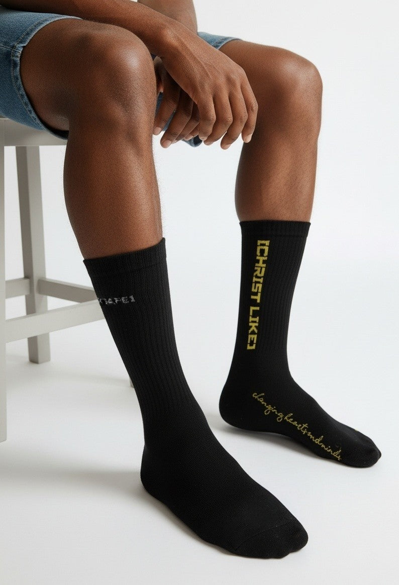 Blacktapechamchristlike Night Sun crew socks in black cotton with gold embroidered Christ Like text on leg