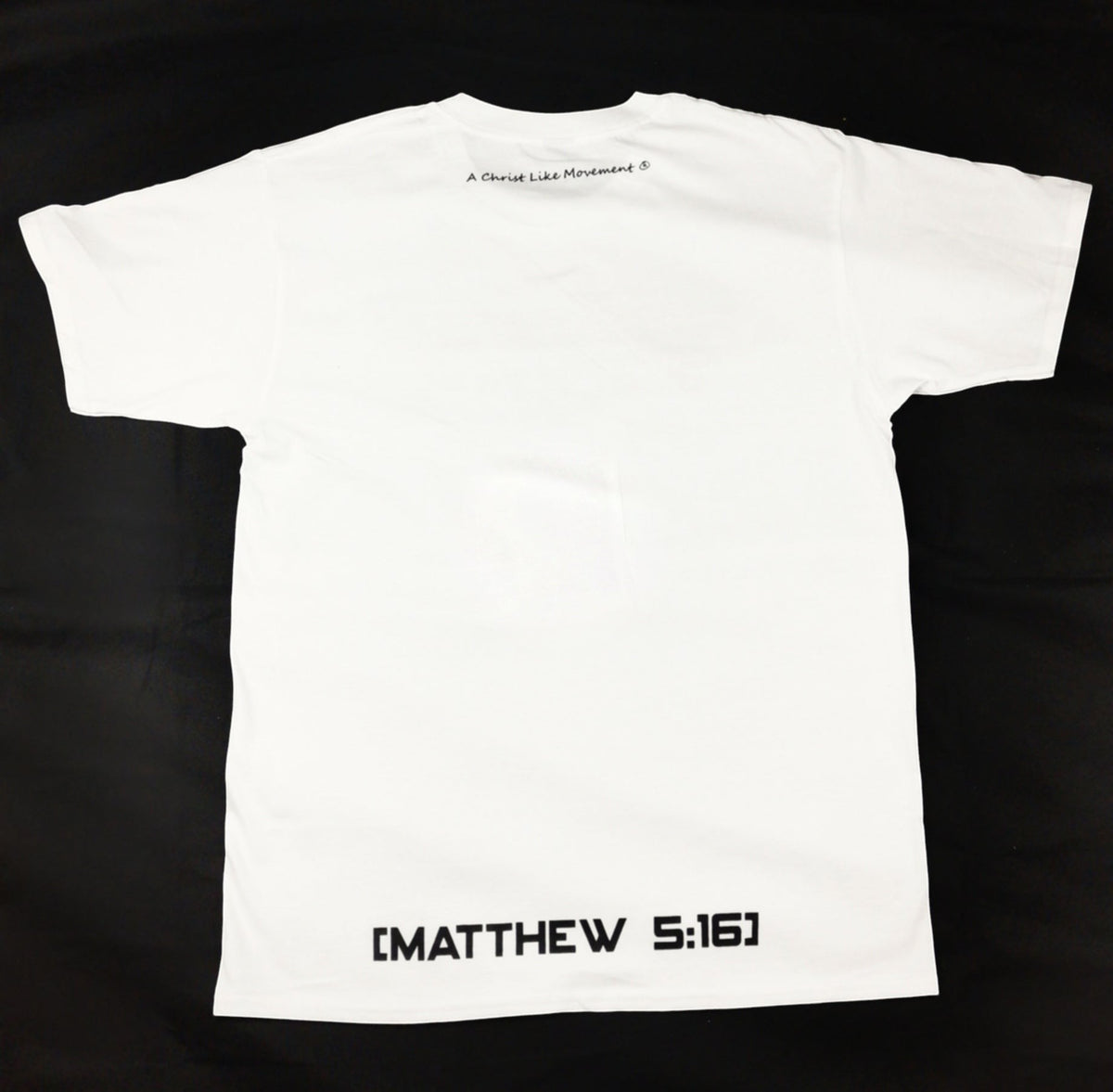 Back view of a white Blacktapechamchristlike cotton crew neck t-shirt with black text print.
